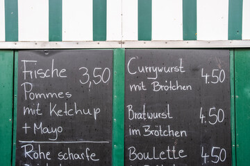 Handwritten Berlin street food menu on a chalkboard displaying texture, authenticity and daily life details that highlight a casual German food environment