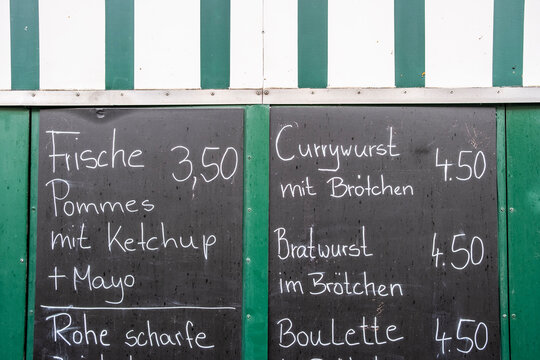 Handwritten Berlin street food menu on a chalkboard displaying texture, authenticity and daily life details that highlight a casual German food environment