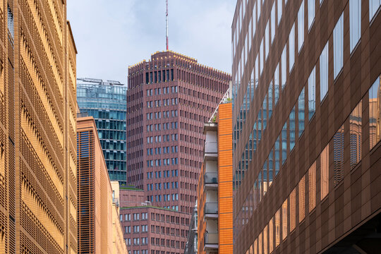 Berlin business district towers rising with geometry and contrast as sunlight shapes the architecture, forming a strong skyline perspective within the city corporate environment