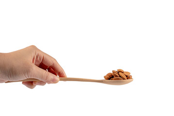 Wooden spoon with almonds in hand on transparent background