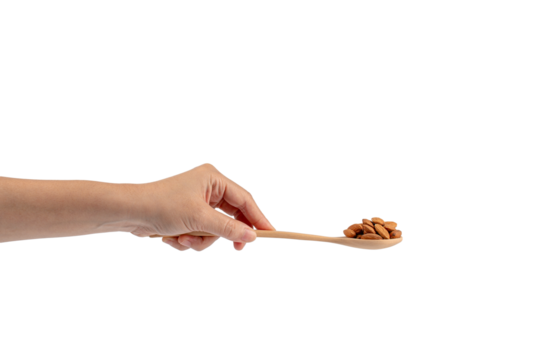 Wooden spoon with almonds in hand on transparent background