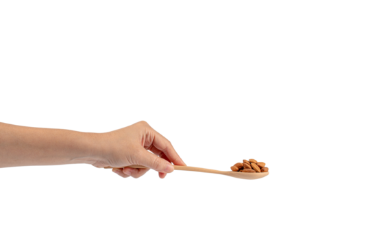 Wooden spoon with almonds in hand on transparent background