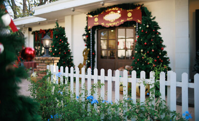 close-up view, white fence with christmas tree decorate at a door in winter, celebrate in christmas holiday