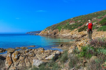 Exploring rocky Asinara Island coastline. Sardinia, Italy