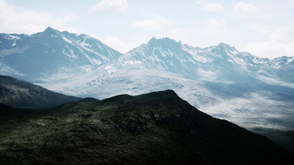 Bright light illuminates towering mountains, showcasing their rugged peaks and valleys. A serene landscape unfolds, inviting exploration and adventure in nature’s grandeur.