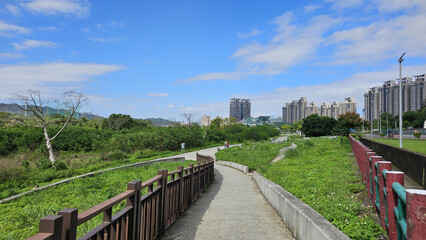 Taipei City, Taiwan. November 15, 2025. Scenic riverside riding U-Bike cycling path in Xindian with open green landscape and clear sky creating a relaxing eco-friendly outdoor atmosphere