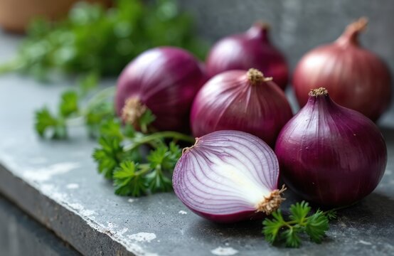 Several red onions with green parsley. One onion cut half shows inside texture. Vegetables on grey table. Organic healthy nutrition concept. Food photography for culinary blogs magazines.