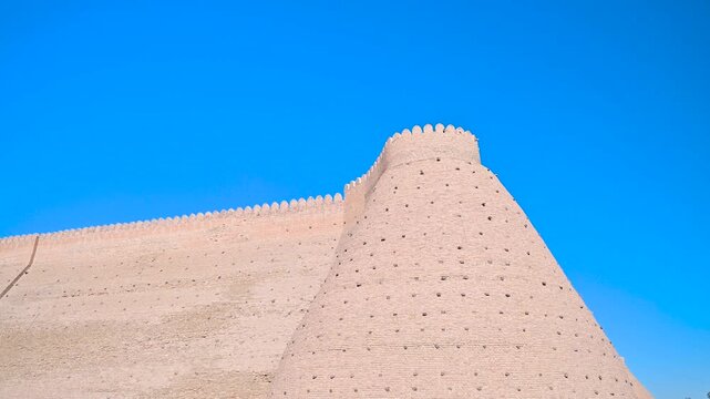 A closer look at the massive brick walls of the Ark Fortress in Bukhara, Uzbekistan, emphasizing their traditional construction and historic defensive design.
