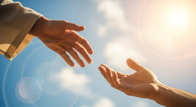 Close-up of Jesus' hand reaching out for salvation to a man's hand, isolated on a sky background and with sunlight. Miracle of saving the life of Jesus Christ, the Son of God, salvation of the soul