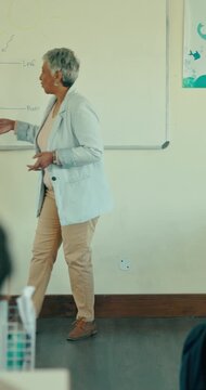 Woman, education and teacher in classroom, speaking and knowledge with lesson. Mature person, learning and whiteboard with advice, class and attention with support, teaching and academic test