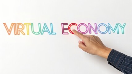 Hand pointing to the word virtual economy isolated on white background