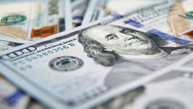Close-up view of various banknotes, featuring detailed textures and colors, showcasing the intricate designs and security features of currency in a visually appealing arrangement