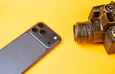 Latest mobile phone camera comparison with old style slr camera on yellow