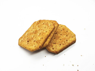Stack of delicious crackers with seasoning on a clean white background