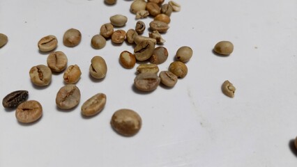 Close-up of raw coffee beans with natural earthy tones, perfect for use in food blogs, product packaging, coffee shop promotions, and agricultural marketing. This detailed texture photo appeals to buy