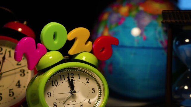 Alarm clock with 2026 and globe background, Colorful alarm clock displaying the year 2026, symbolizing time and global awareness - Powered by Adobe