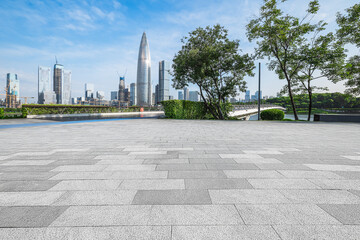 Empty square floor and modern city skyline with skyscrapers.