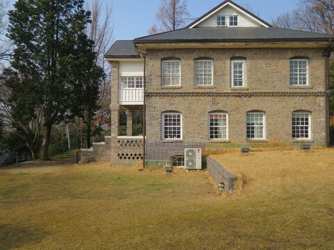 TypicaI residential house exterior in urban South Korea, showing everyday urban living environment.