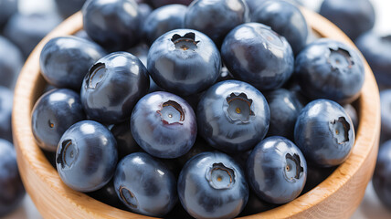 A high resolution close up of ripe blueberries piled in a small wooden bowl showing the rich color texture and natural healthy fruit snack