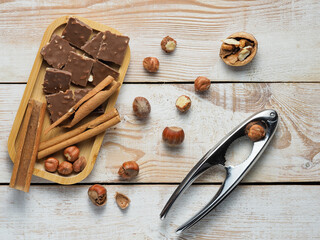 walnuts and hazelnuts,cinnamon, chocolate with nuts, nutcracker, background, Christmas wallpaper on a wooden countertop