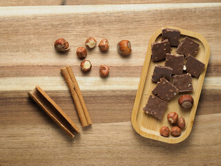 walnuts and hazelnuts,cinnamon, chocolate with nuts, nutcracker, background, Christmas wallpaper on a wooden countertop