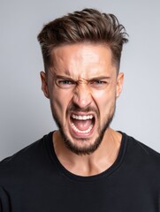 Angry man shouting with aggressive facial expression. Emotion of frustration and stress. Concept for rage, protest, or intense disappointment.