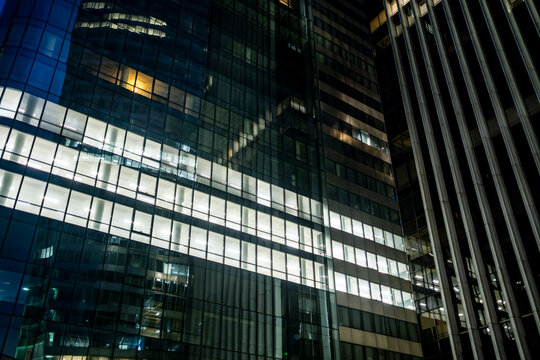 Reflection-driven urban architecture with glass surfaces and corporate finance tension captured from a dramatic low-angle viewpoint among towering skyscraper forms in La Defense Paris - Powered by Adobe