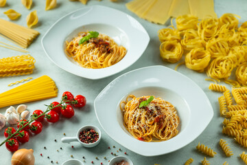 Plates of spaghetti bolognese with fresh ingredients