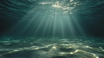 Sunlight rays piercing deep blue ocean water to the seabed