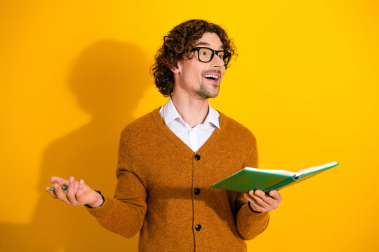 Bright student model holds notebook and marker while presenting ideas against a vibrant yellow background for a friendly promotional lifestyle image - Powered by Adobe
