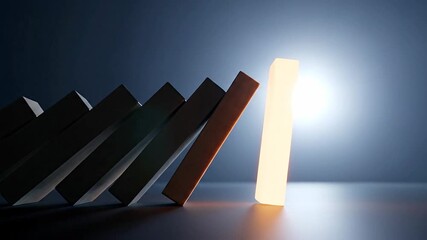 Conceptual image of dominoes falling with one illuminated piece standing strong against the effect of chain reaction representing resilience and impact in dramatic lighting