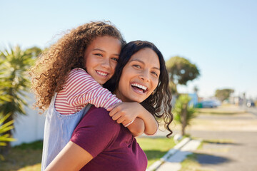 Fototapeta premium Happy multiethnic woman piggybacking her cute little girl