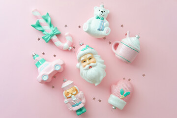 Bright pastel pink Christmas ornaments flat lay, full of festive toys.