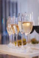 Celebrating special moments with elegant glassware filled with refreshments at a festive gathering in a well-lit venue during the evening