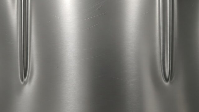 Sleek Silver Metal Surface with Vertical Indentations.