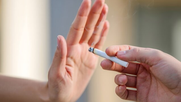Hand Stopping a Cigarette - No Smoking Concept