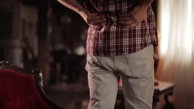 Man with hip, back and sciatica pain at home.