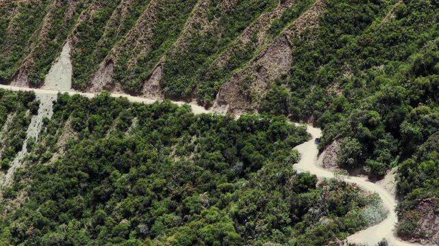 Car driving windy dirt road dust Soray Laguna Lake Humantay Sulcantay Trek Peru Per&uacute; aerial drone clouds blue skies high altitude elevation Peruvian Andes Mountain Range peaks forward follow motion