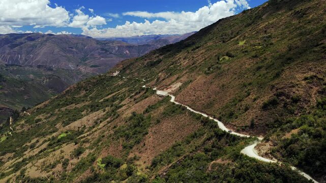 Car driving windy dirt road Soray Laguna Lake Humantay Sulcantay Trek Peru Per&uacute; aerial drone clouds blue skies high altitude elevation Peruvian Andes Mountain Range peaks forward motion