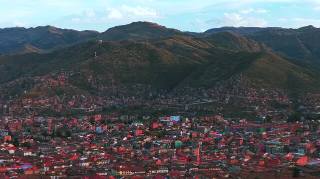 Cusco Cuzco Per&uacute; cityscape aerial drone Vive en el Peru mountain side high altitude colorful Inca city neighborhood buildings Plaza De Armas sunset golden hour blue skies clouds circle left motion
