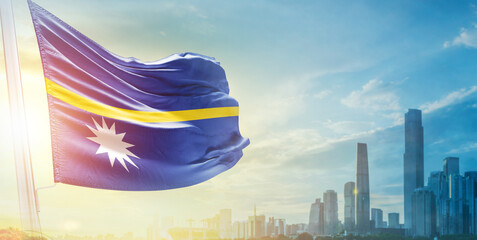 Nauru flag wavering in beautiful clouds with building skyline. The flag with drone shot in...