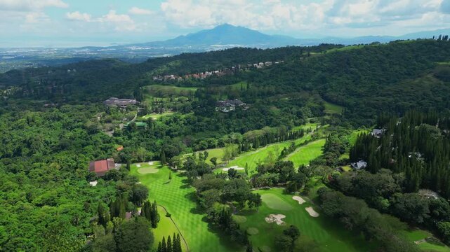 An aerial view near Canlubang Golf and Country Club where Mount Makiling is seen and it shows pine trees, forested hills, and drifting cloud shadows in Calamba Laguna, Philippines