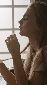 Vertical shot of stressed millennial patient struggling to discuss her emotions with therapist openly during individual session
