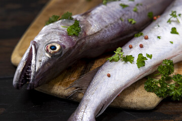 Woman in brown bathrobe touching cream with finger and holding a cosmetic jar closeup