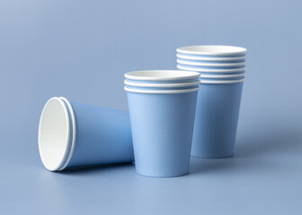 Disposable light blue paper cups closeup, mockup, copy space. No plastic biodegradable single-use