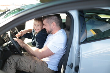 Father and son enjoying a moment together in car
