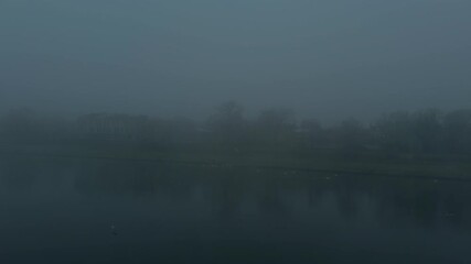 Morning fog in the city. The boulevard and city park by the river are shrouded in fog. - Powered by Adobe