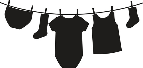 Black silhouette of baby clothes hanging on a rope including onesie socks and shirt flat vector illustration isolated on white background.