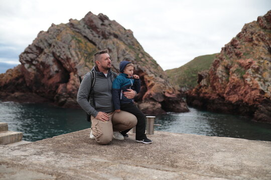 Father and son bonding exploring rocky coast travel - Powered by Adobe