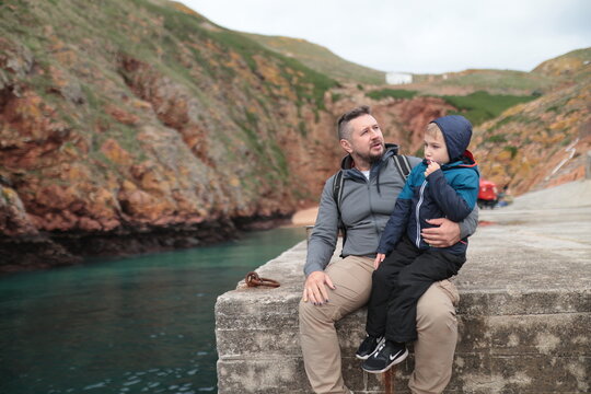 Father and son enjoying view in harbor, island exploring